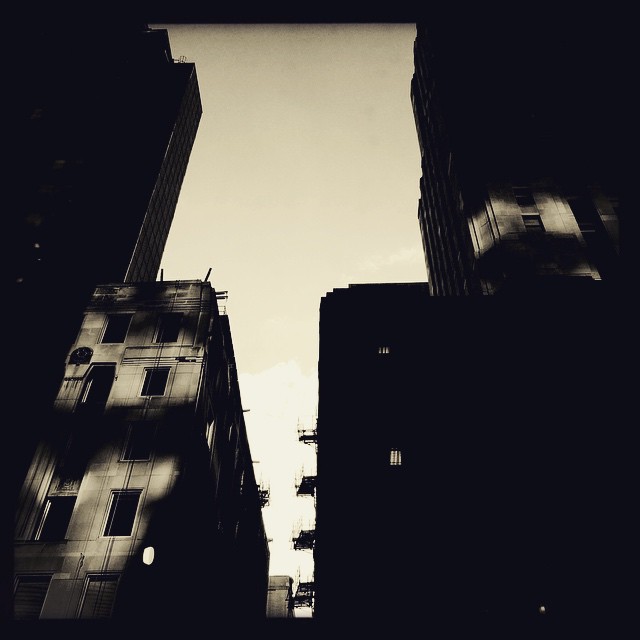 buildings in a dark city and one building is very tall
