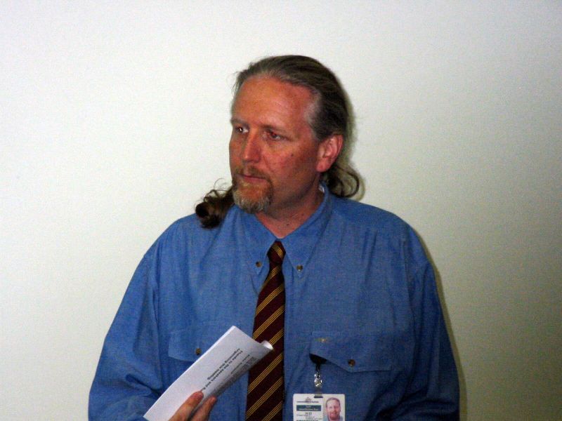 a man is dressed in a blue shirt and tie with a hairdow