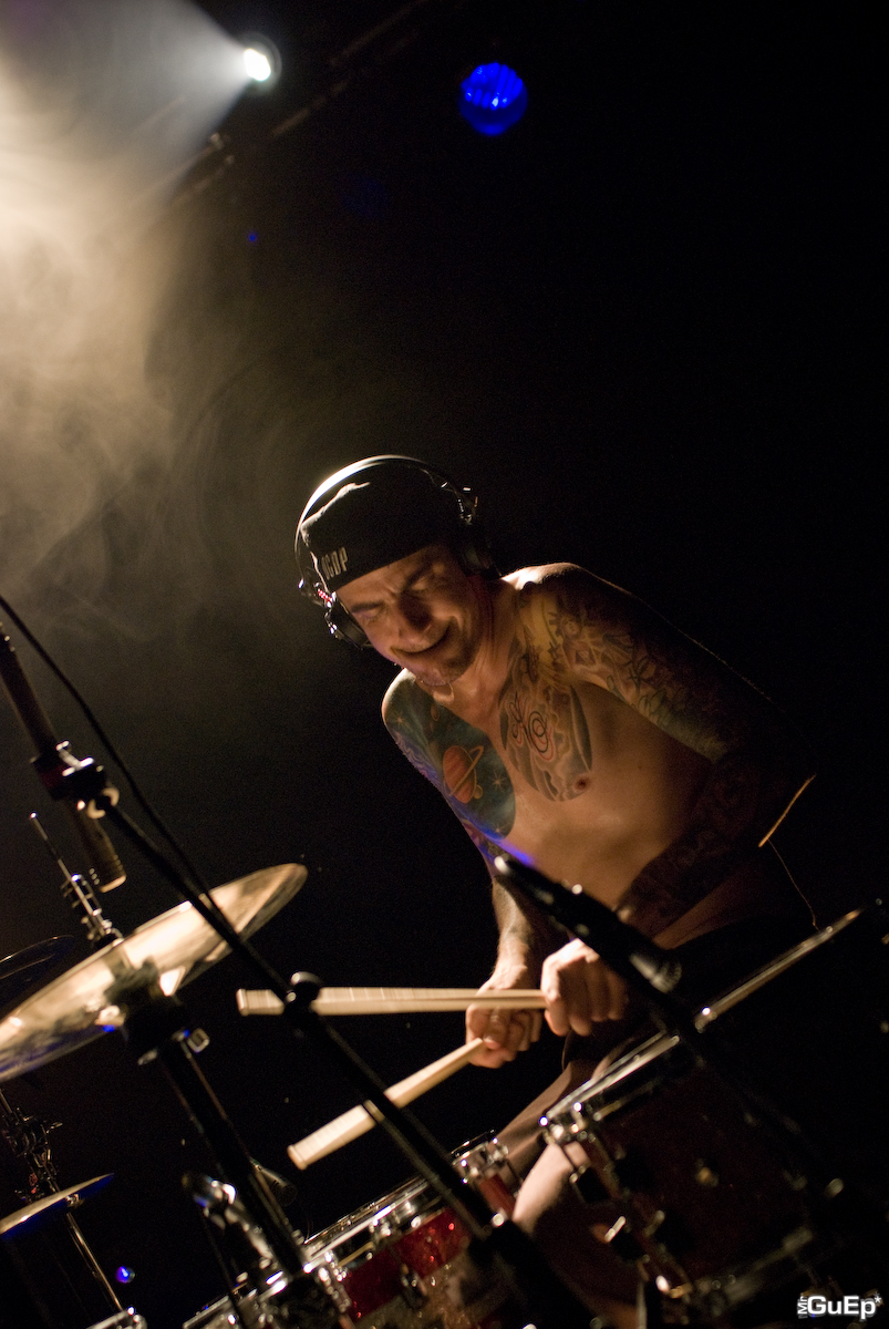 a man in black shorts playing on the drums