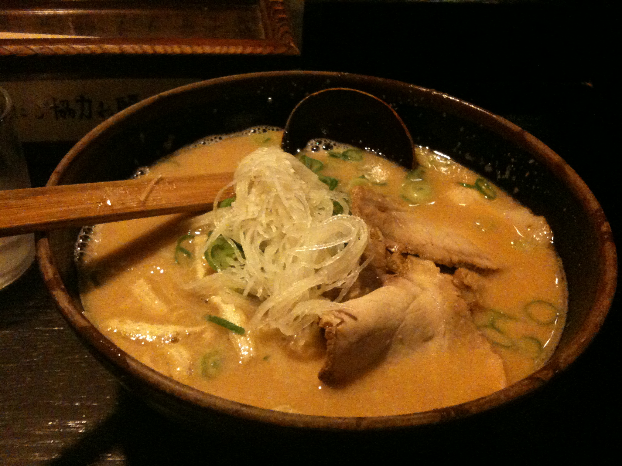 chicken, noodles and cabbage in a brown sauce in a bowl