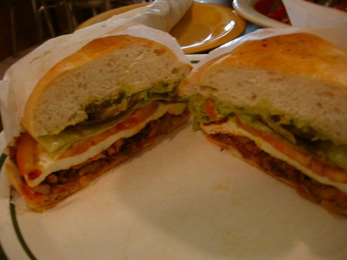 a large sandwich cut in half on a plate