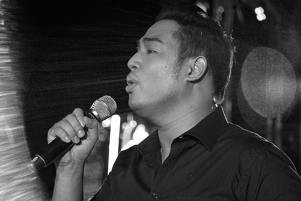 a man holding a microphone up to his face