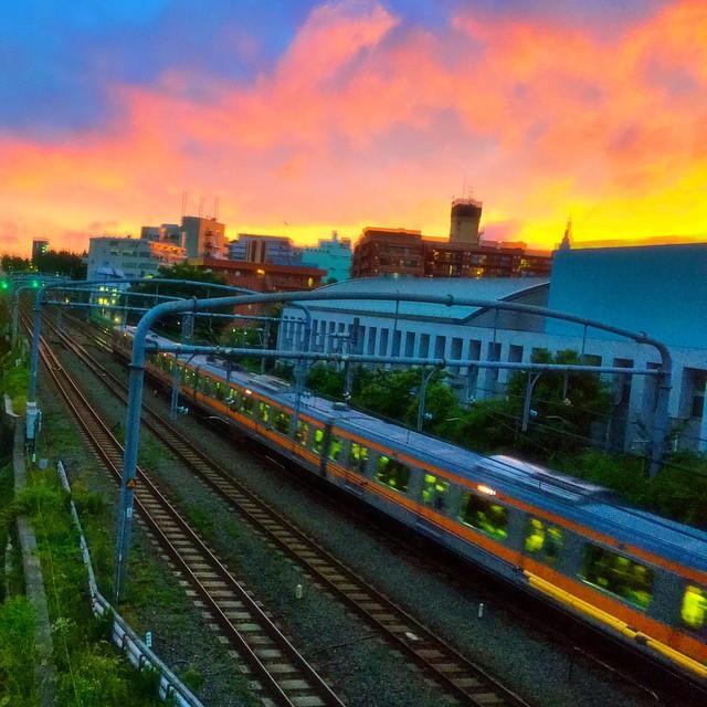 a train is going down the tracks at sunset