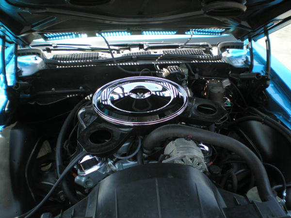 the engine compartment of an old blue car