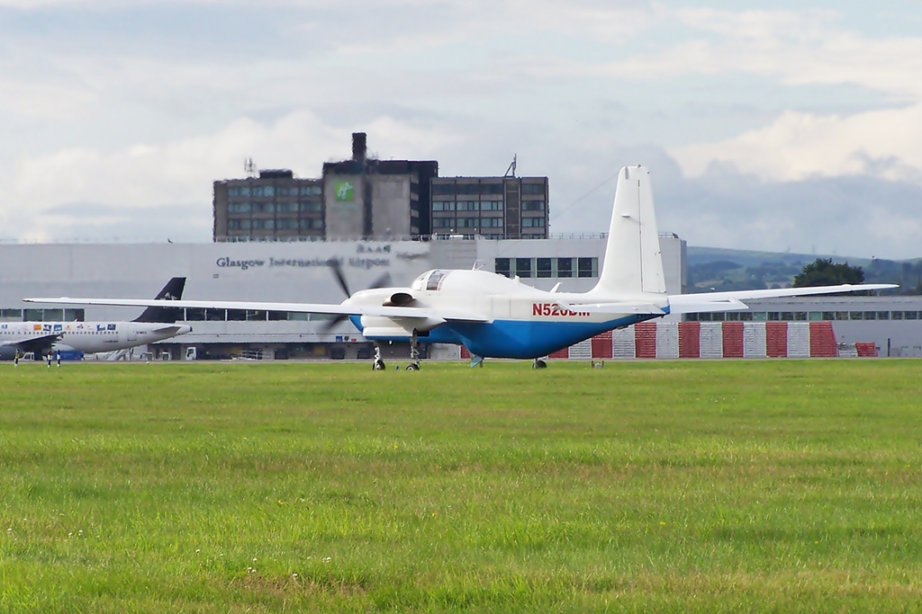 an airplane sitting on the tarmac in front of some buildings