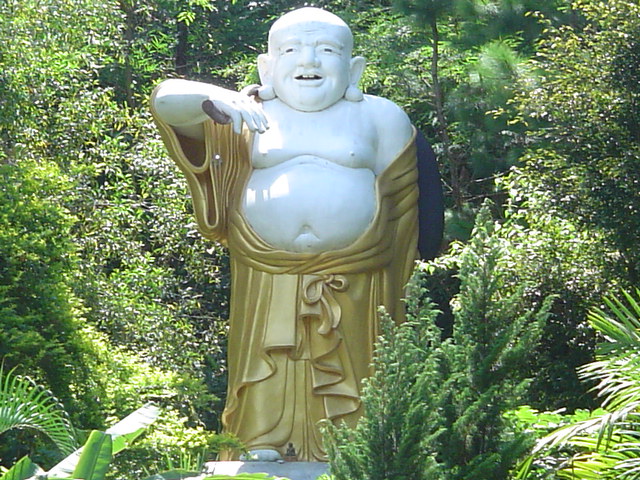 a large golden statue with a white robe on