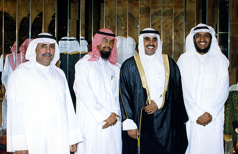 four men in a large group dressed up