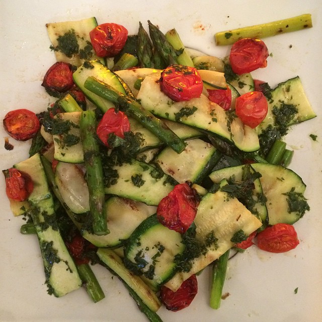 a plate full of vegetables sitting on top of a table