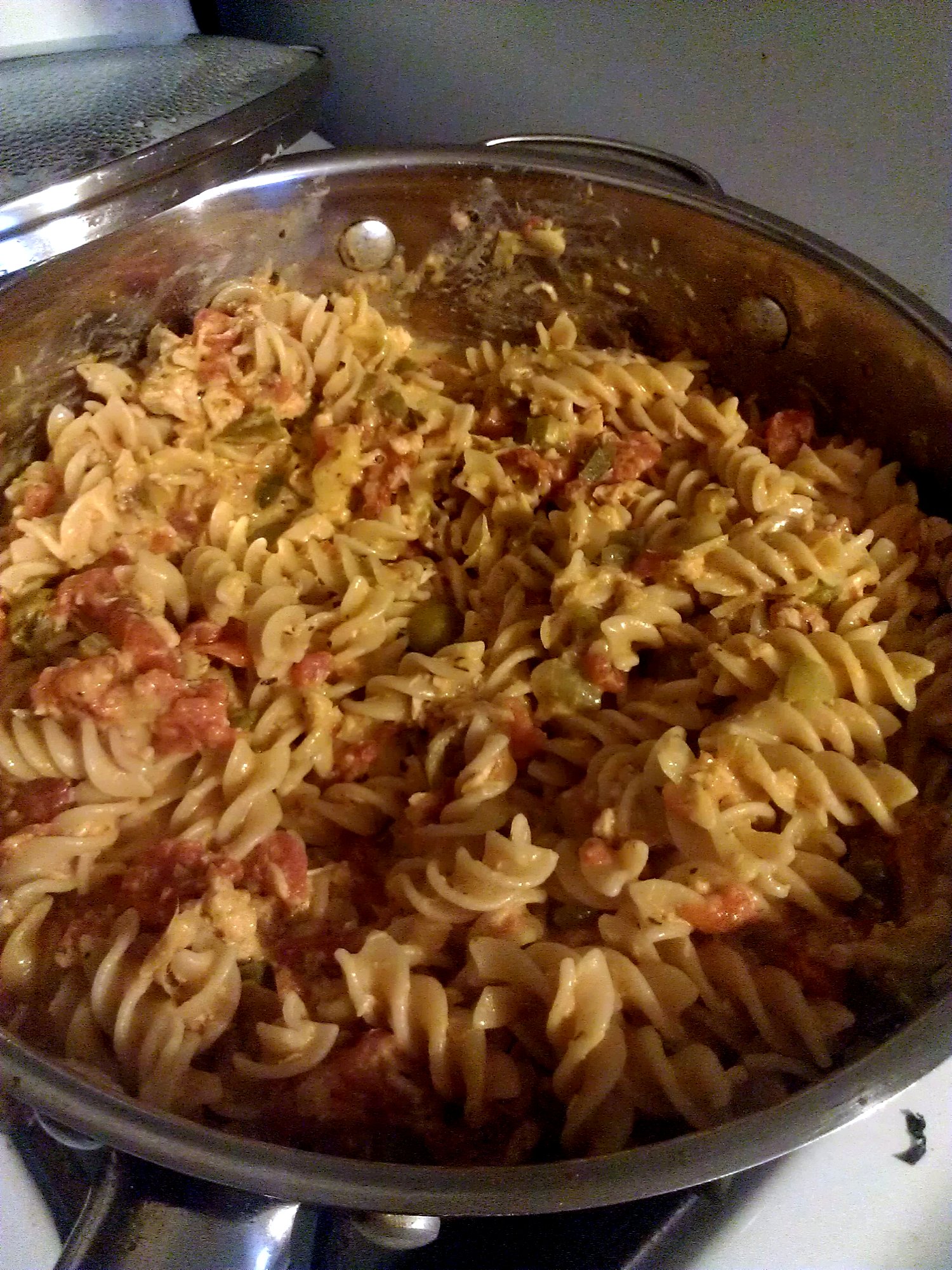 a pan filled with meat and noodles on top of a stove