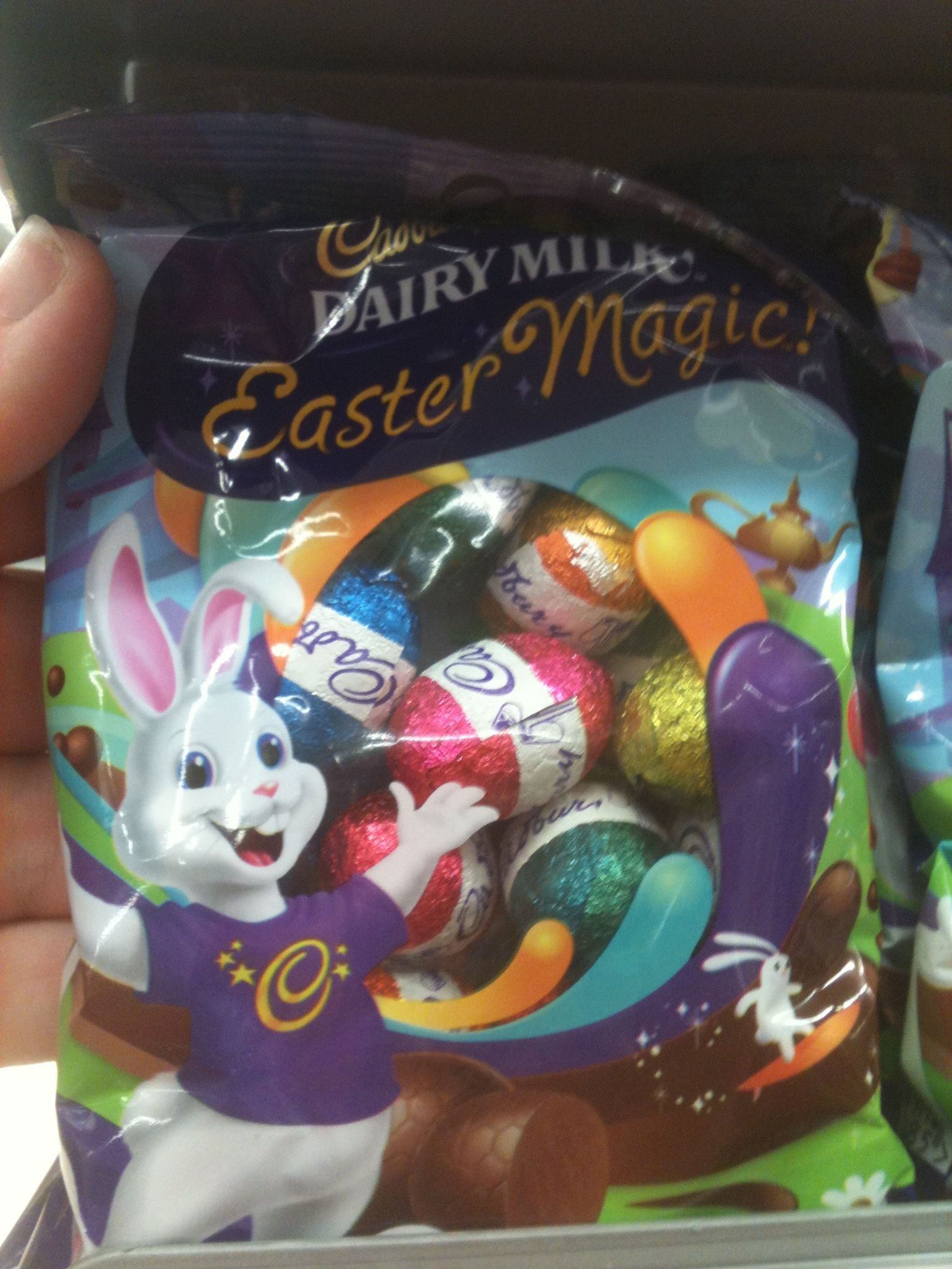 a hand holding a bag of easter eggs