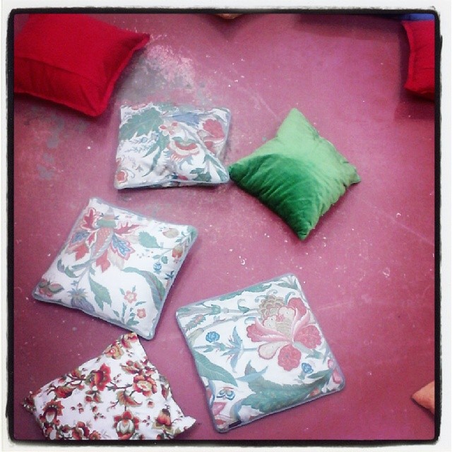 several cushions and pillows laying on the floor