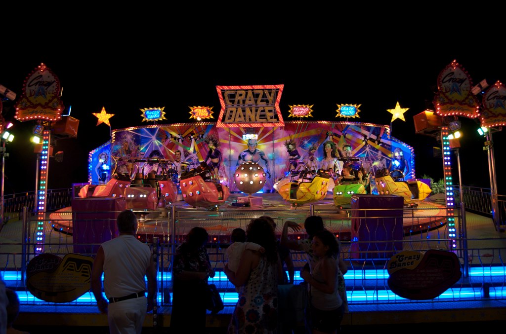 several people watching some floats at night time