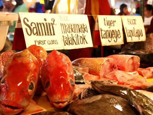 a variety of fresh seafood sits on sale