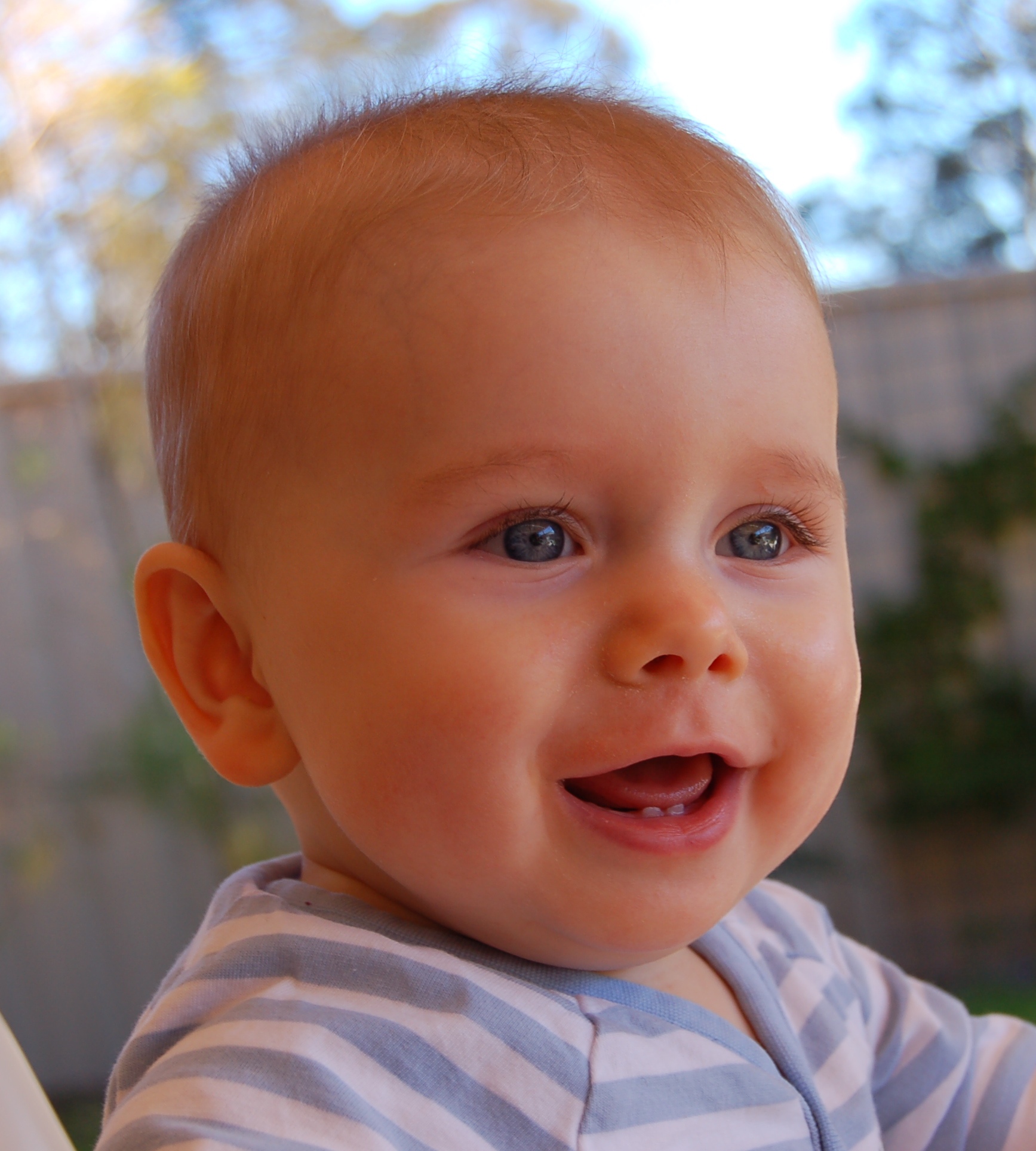 the baby in striped clothes looks back