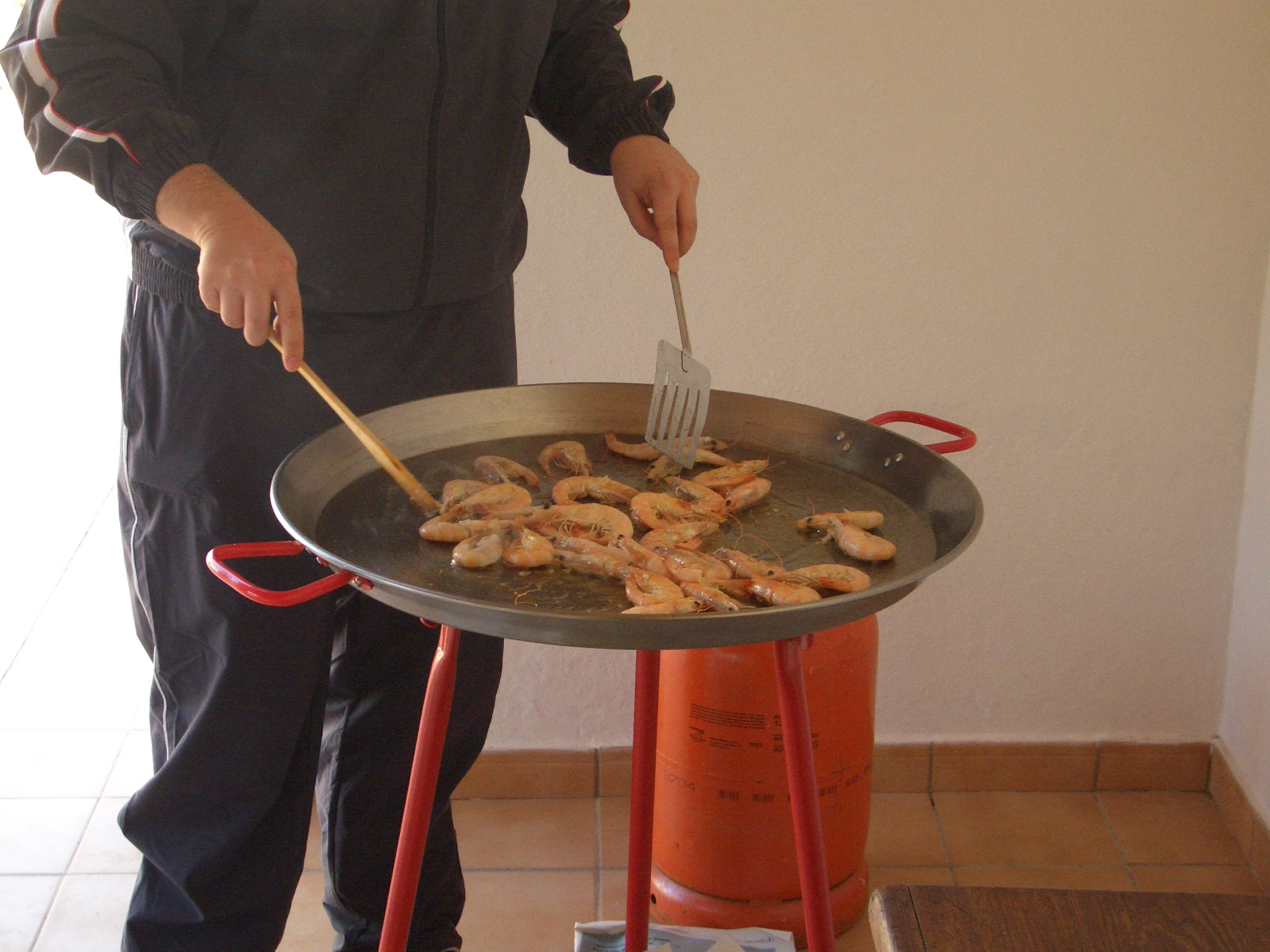 a man standing in front of an omelet on the stove