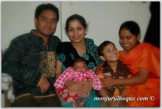 three adults and two children smiling for the camera