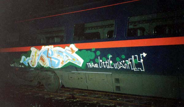 graffiti is written on the side of a train