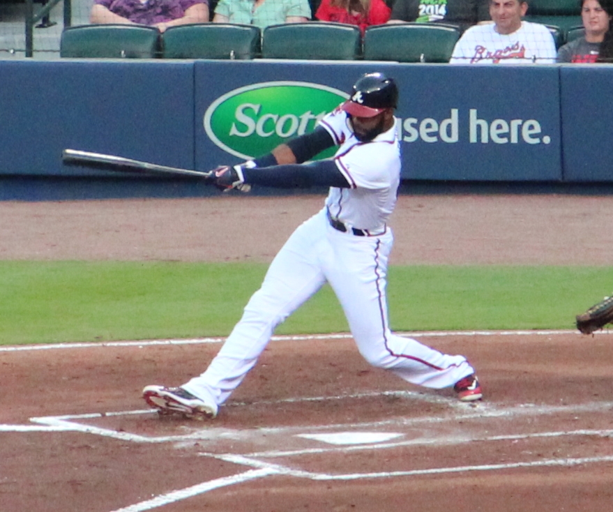 a baseball player at home plate swinging a bat