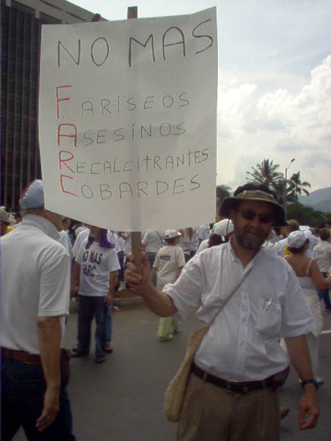 man holding protest sign in the middle of a protest