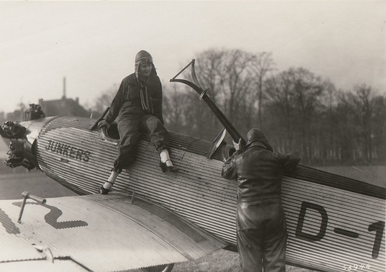 an old po with a person leaning over a small airplane