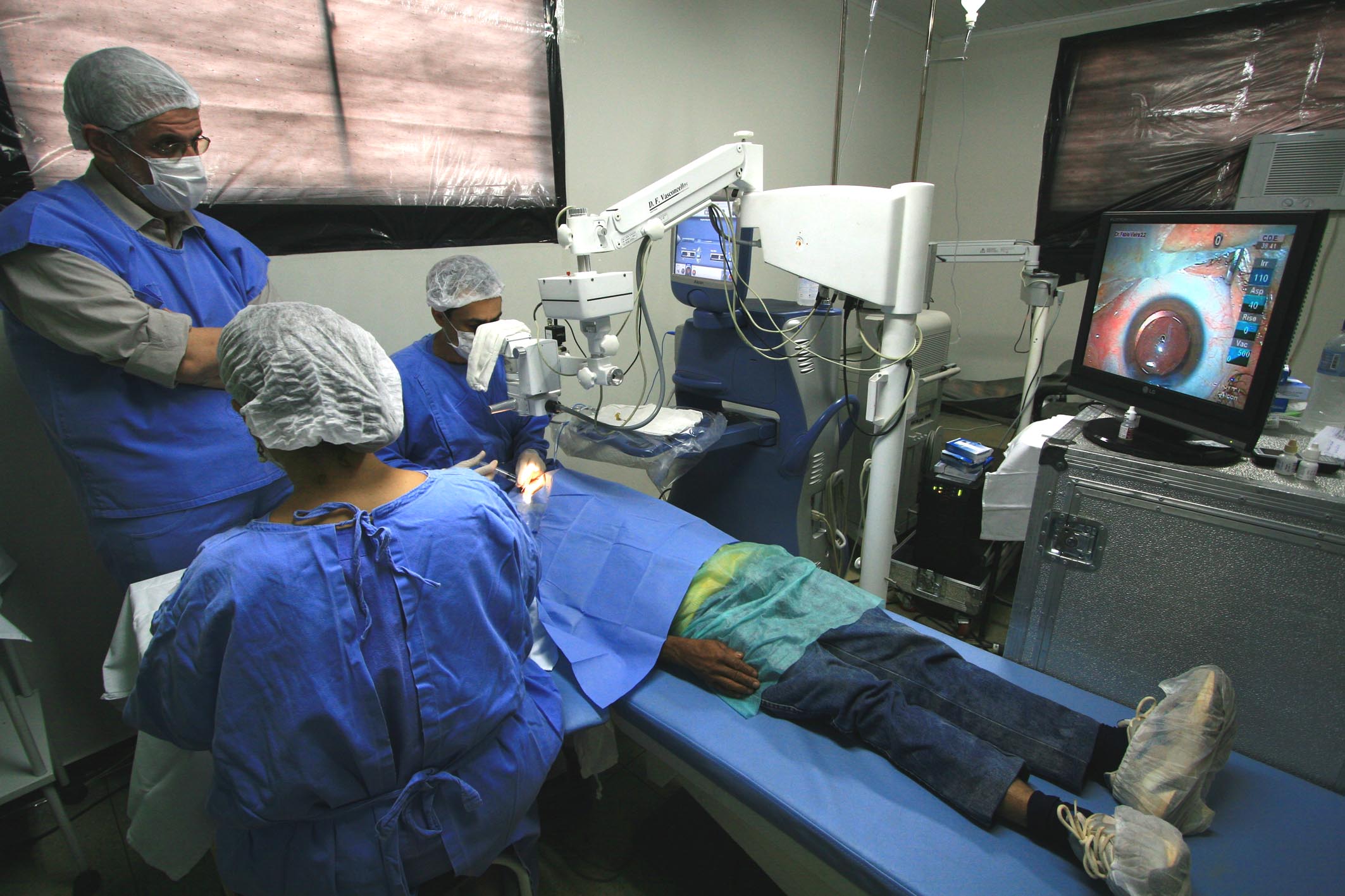 three doctors are performing  in the operating room