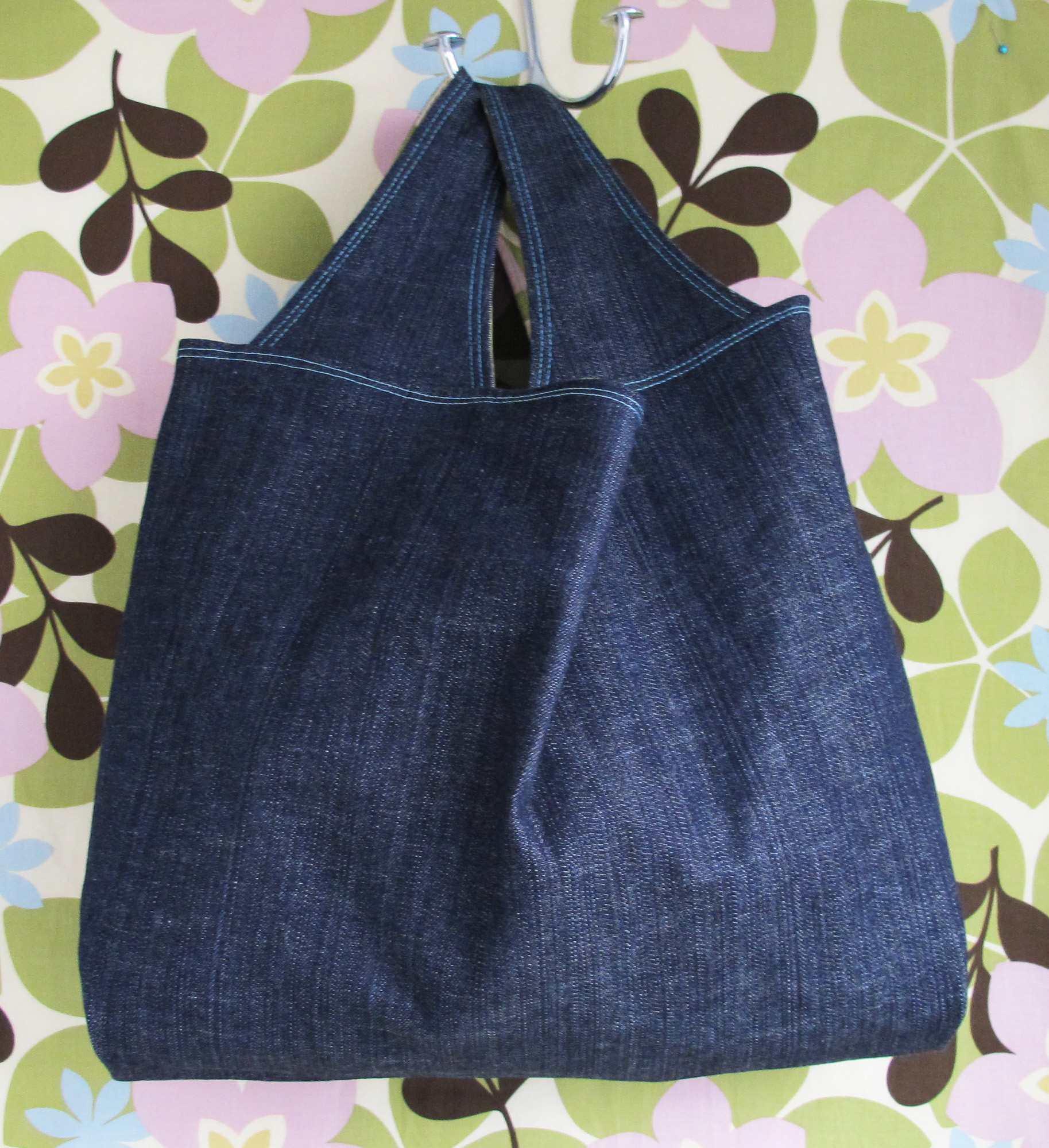 an open jean purse on the floor