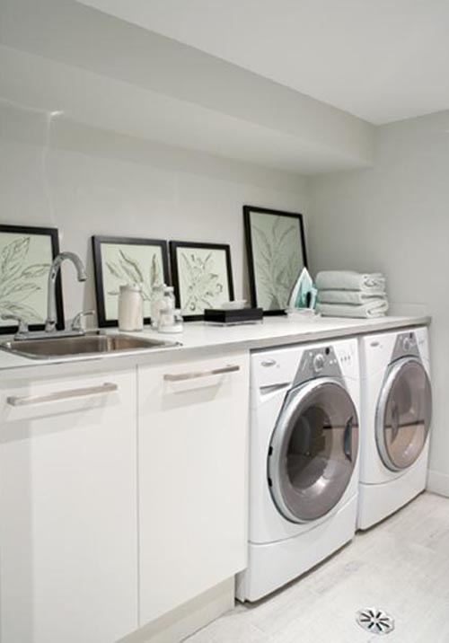 laundry room with a washer, dryer and multiple mirrors