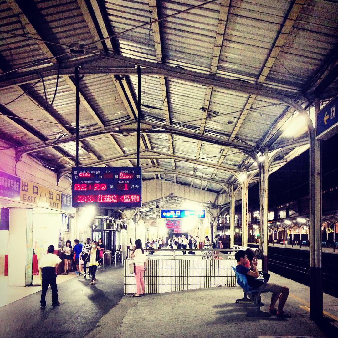 people standing in front of a large train station