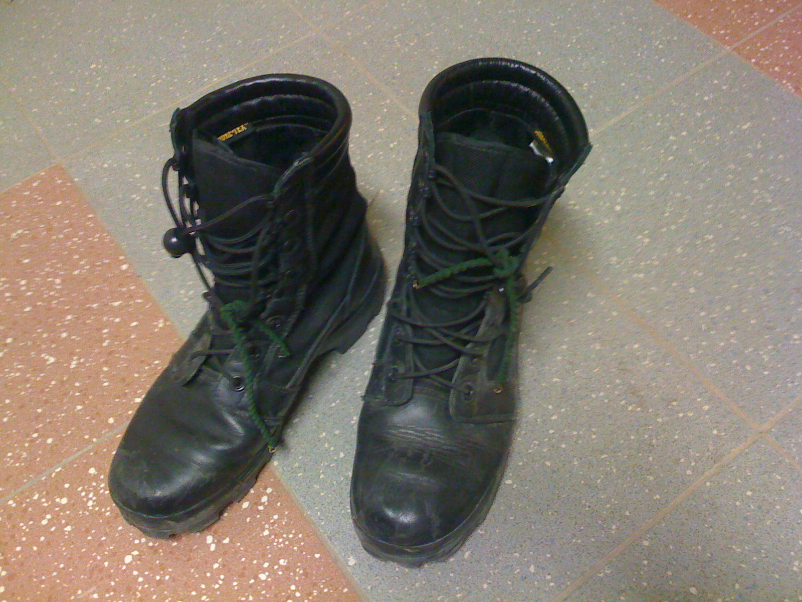 two black leather boots with laces on each