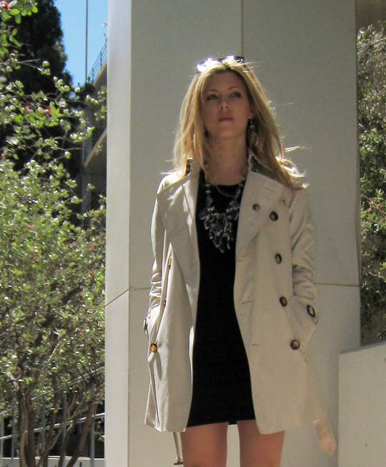 woman in white jacket, black dress and tan boots