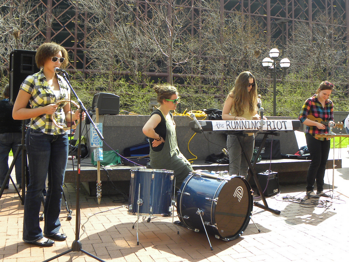 three people are on stage playing instruments together