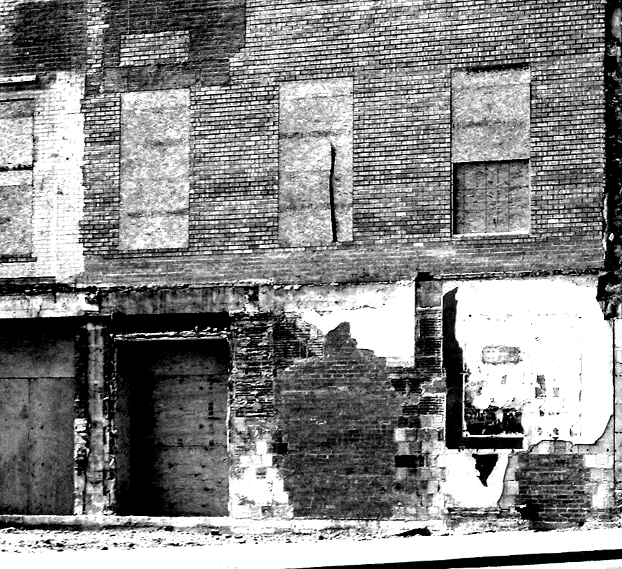 an old building has boarded up doors on it