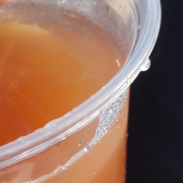 orange juice and a straw with white substance