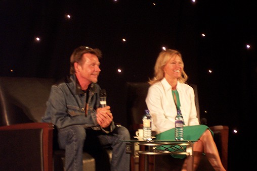 two people sitting on chairs at a meeting