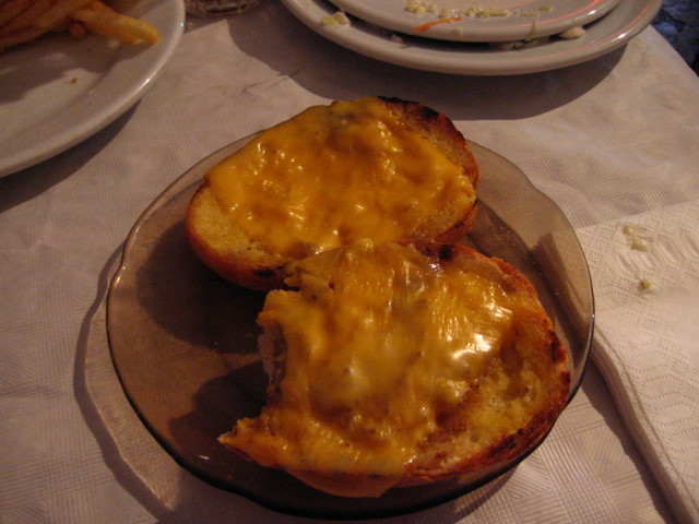 the bread is topped with cheese on top of the plate