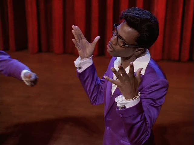two men performing a dance move, one of the men is clapping