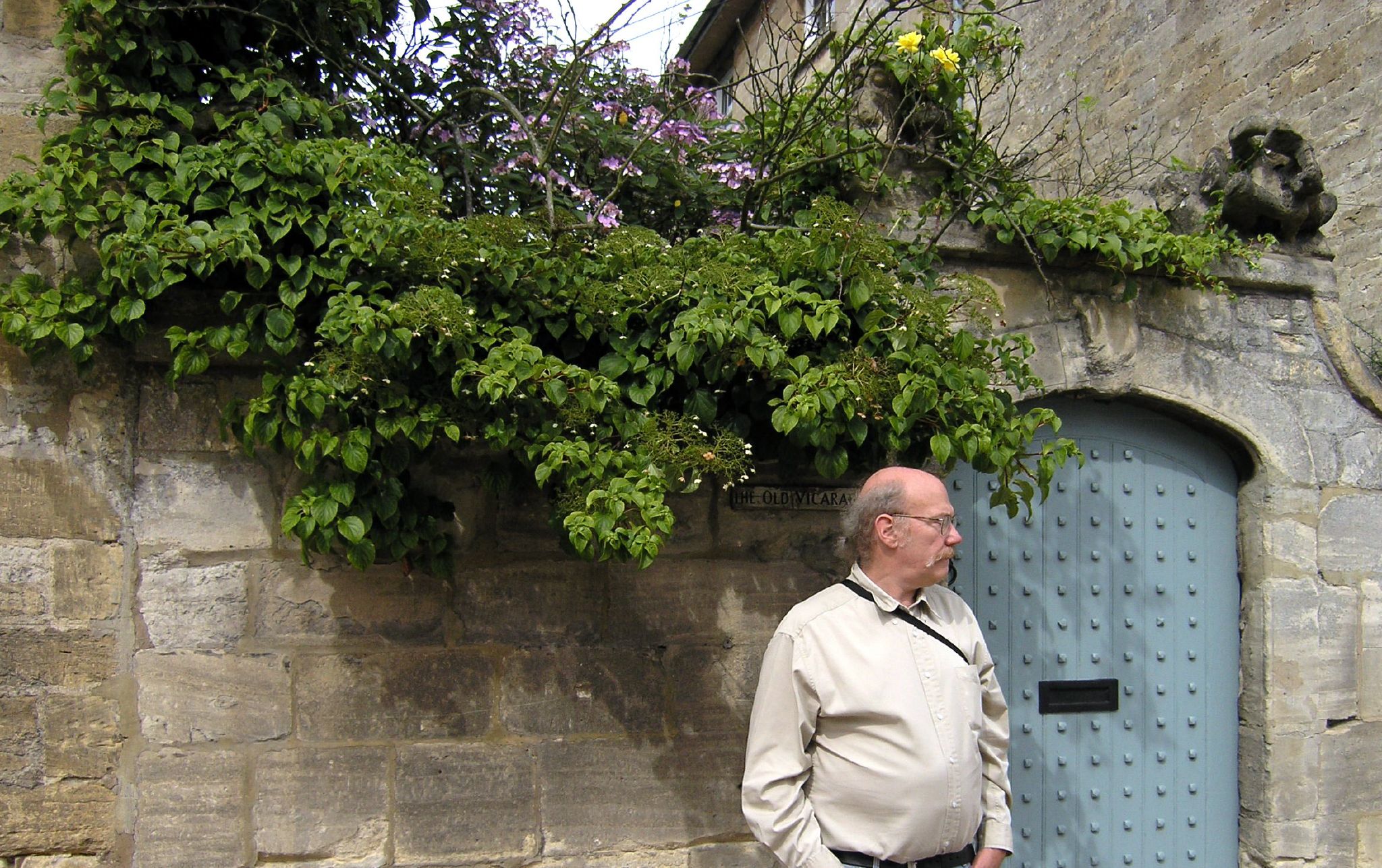 a man stands against a wall next to a door