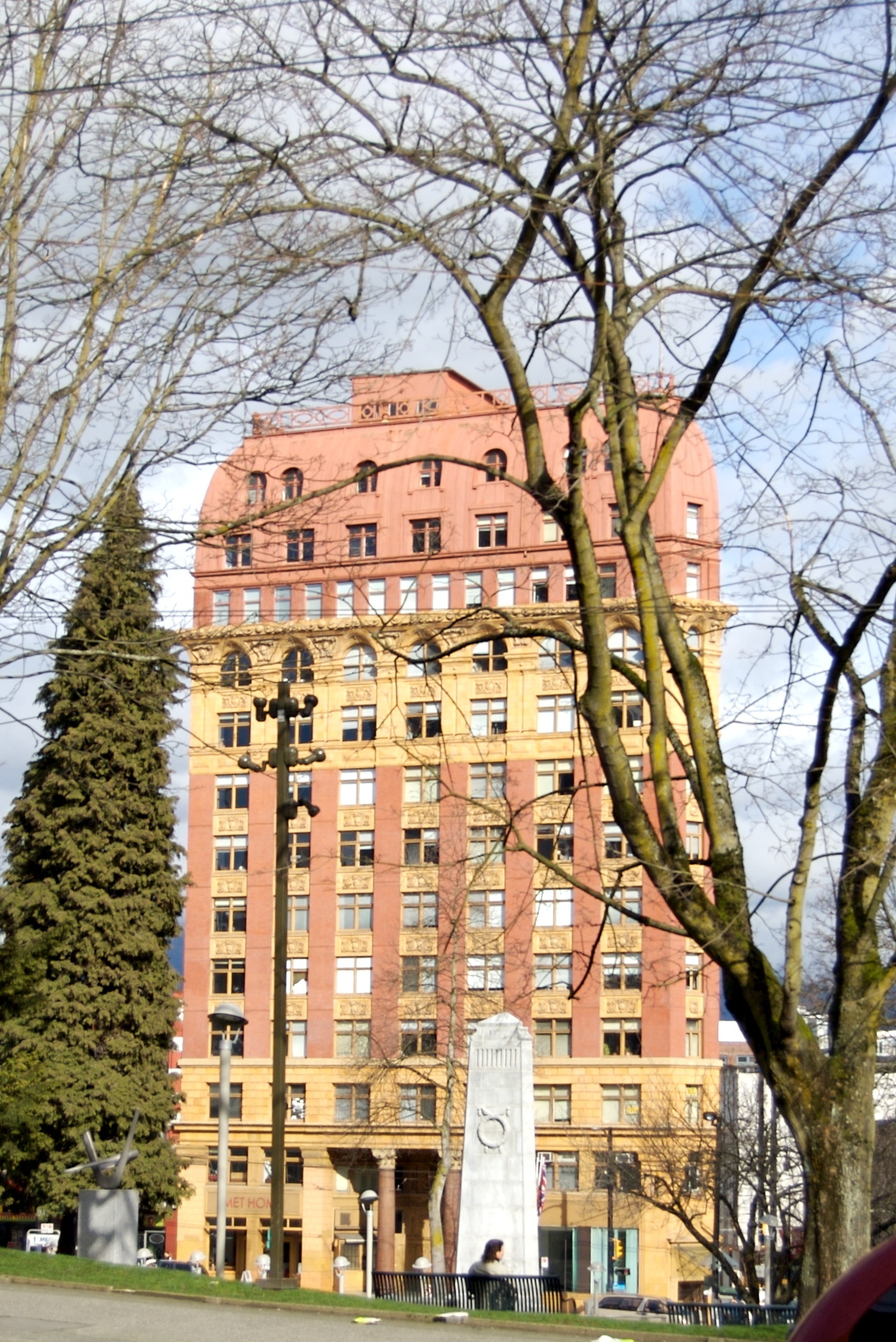 trees and people in front of an apartment building