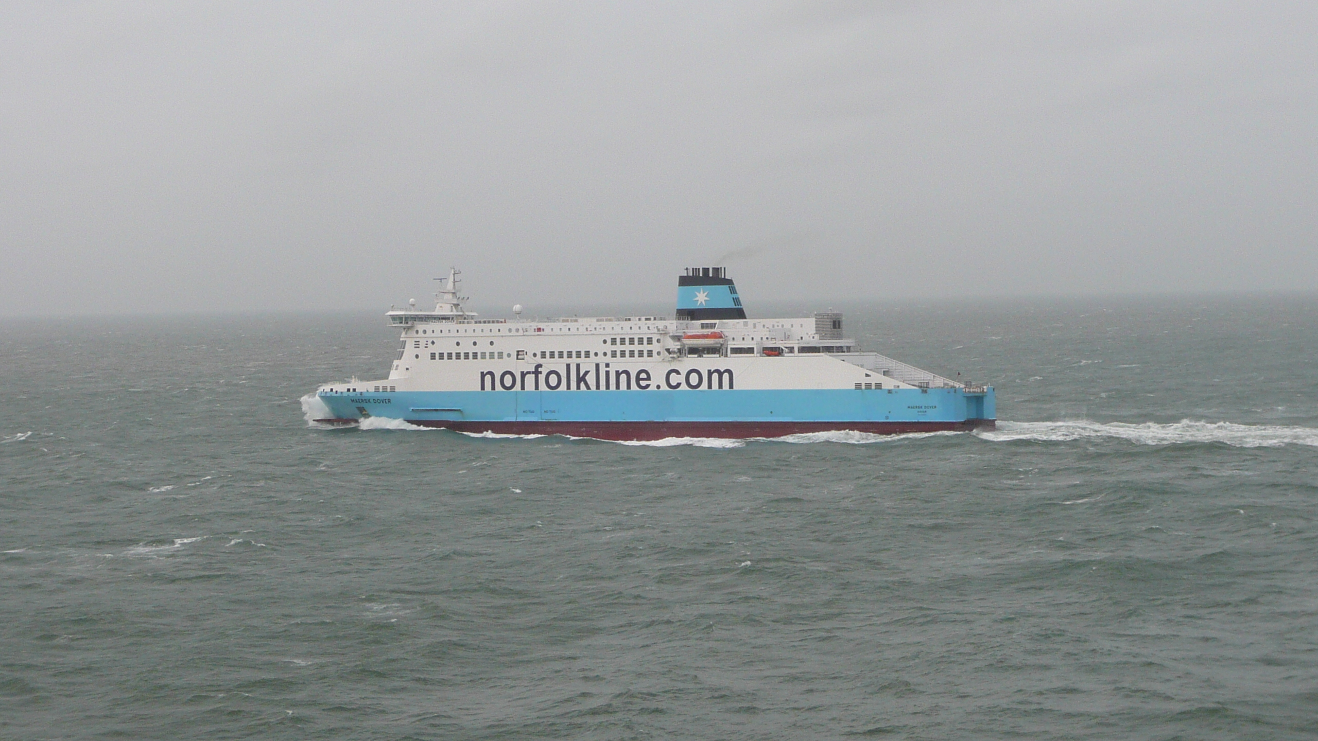 a big blue and white boat in a body of water