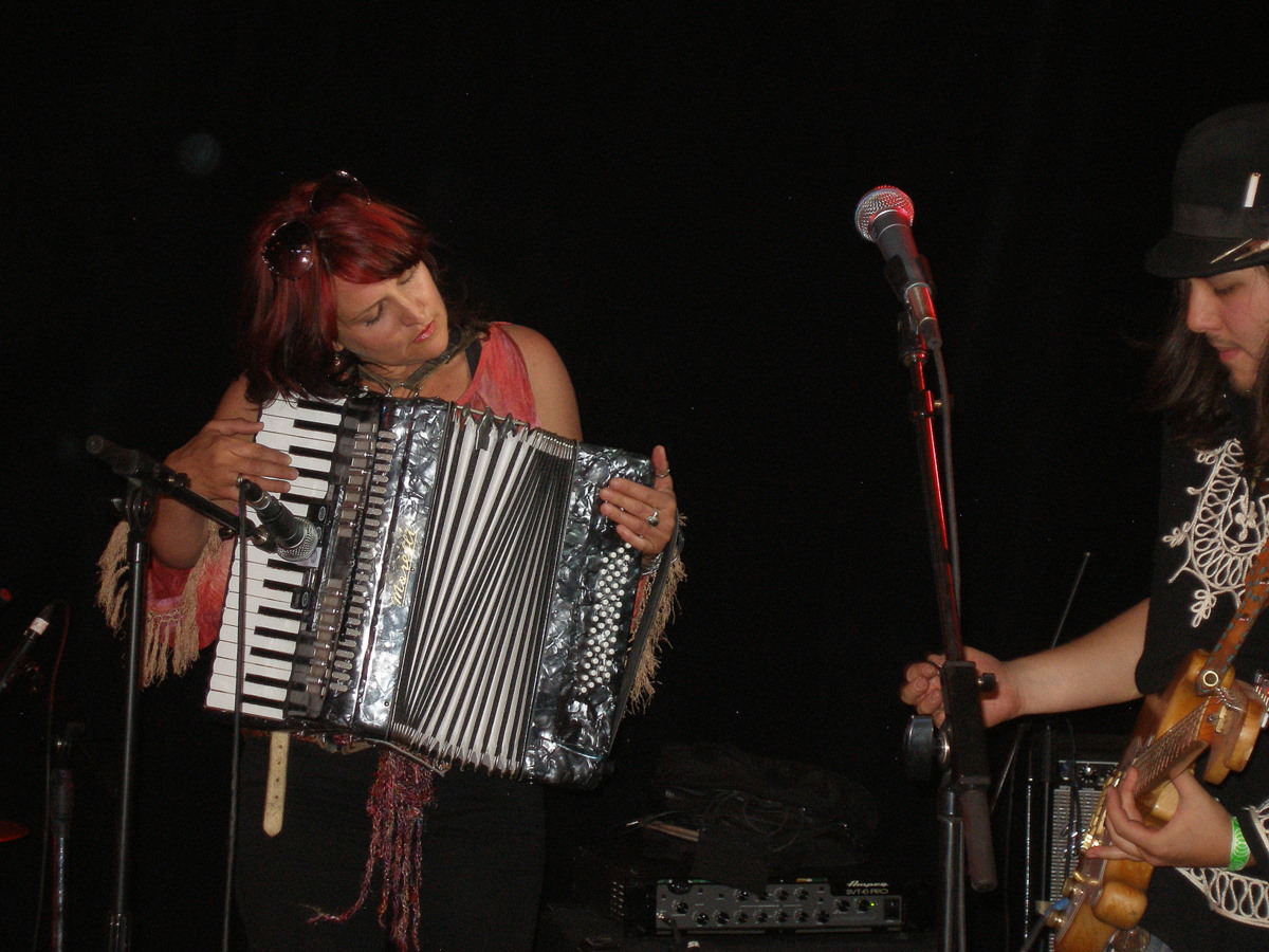a man and woman playing the accordion together