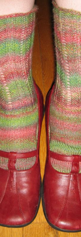 a pair of red shoes with a multicolored pattern