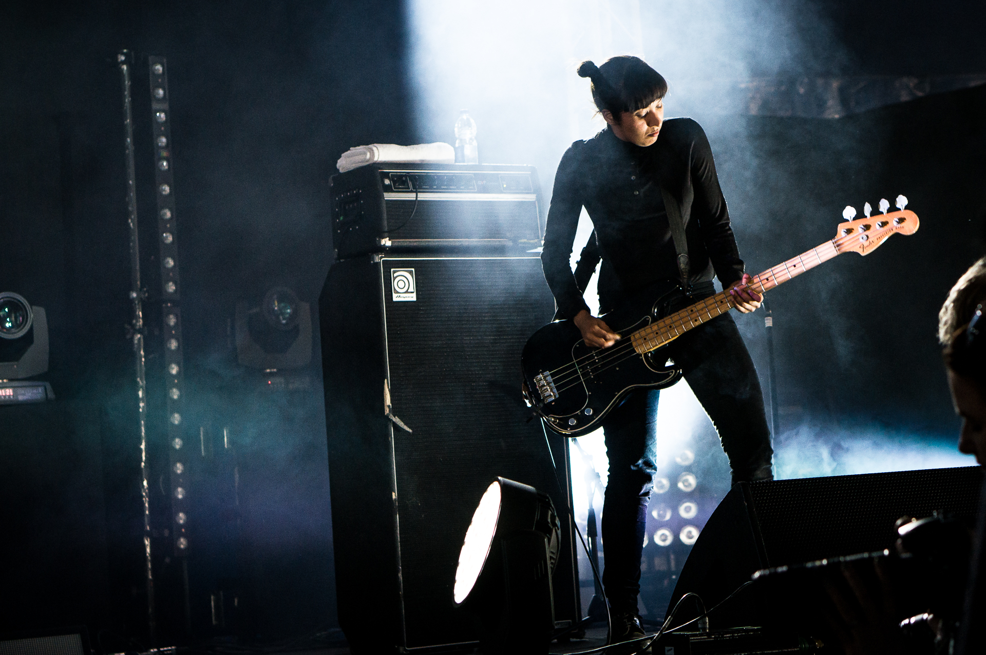 a man holding an electric guitar on stage