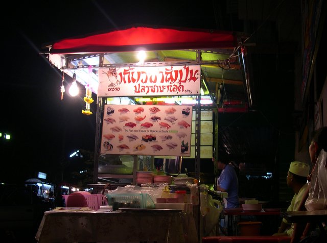 a food stand is lit up at night
