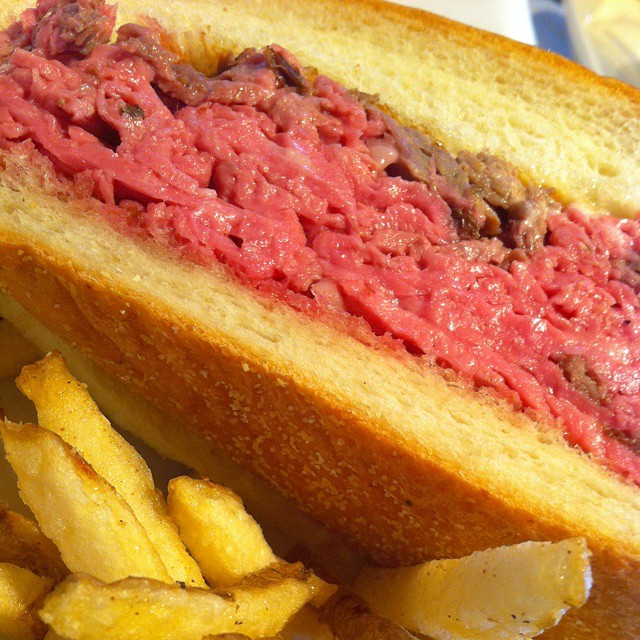 a hamburger sitting next to french fries with ketchup