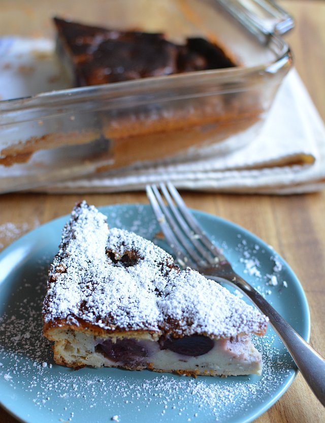 a plate with two pieces of pie covered in powdered sugar