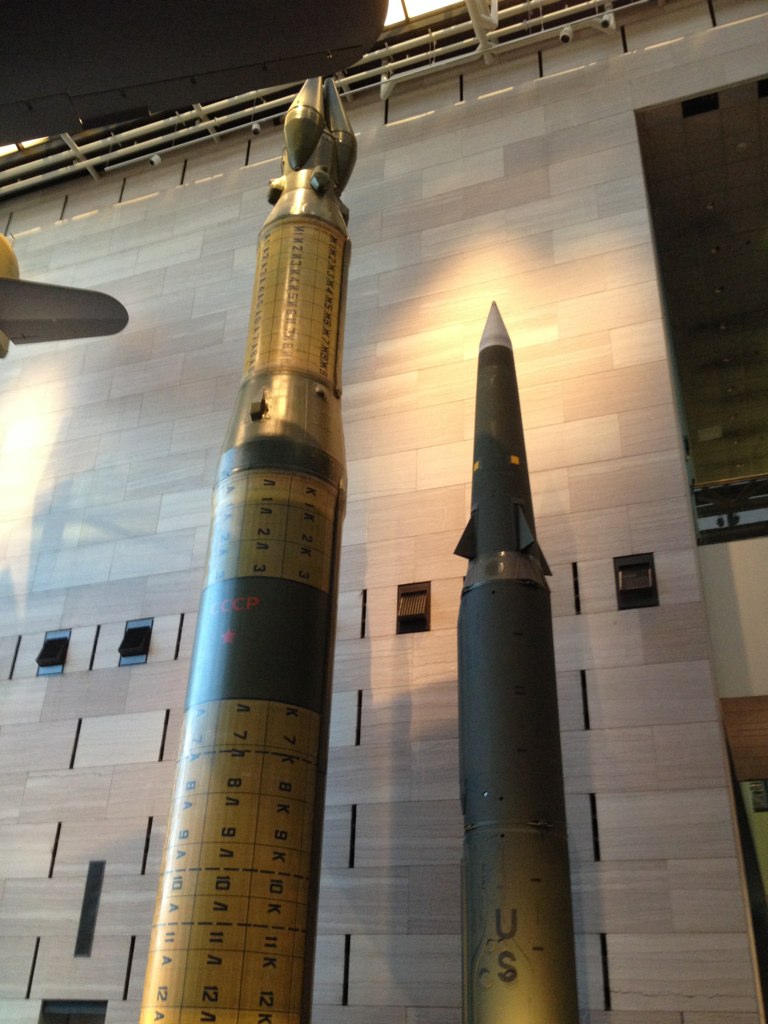 two large rockets on display in a museum