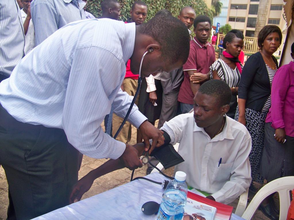 a man has his hands on another man's shoulder as he points