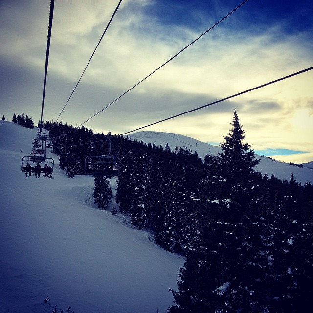 a ski lift going up a snowy hill