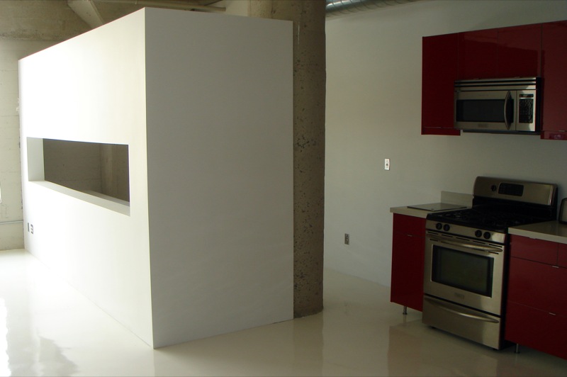 a kitchen with two ovens and a stove