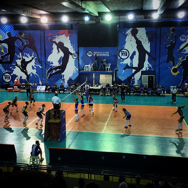 people in blue uniforms stand on a hard wood court